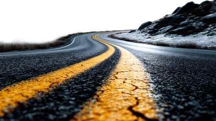 Winding asphalt road with yellow lines through a snowy mountain landscape in winter, offering a scenic view and a sense of travel