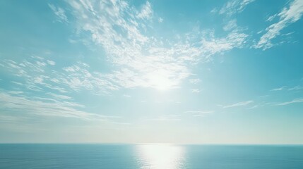 Obraz premium Bright Blue Sky Over Calm Ocean with Sunlight Reflection