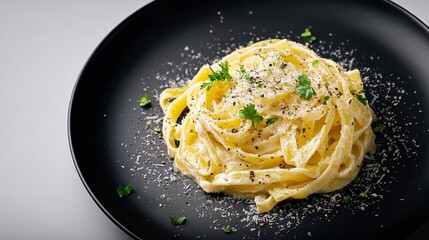Photograph of spaghetti carbonara served on a black plate with parsley and pepper.