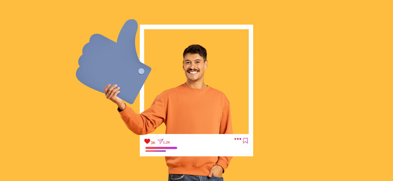 A man in an orange sweater expresses positivity by giving a thumbs up while holding a large like symbol. Bright yellow background enhances the cheerful vibe, perfect for social media engagement.