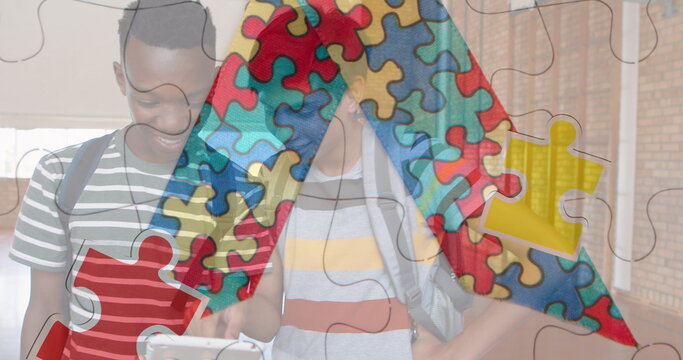 Image of puzzle over diverse schoolchildren