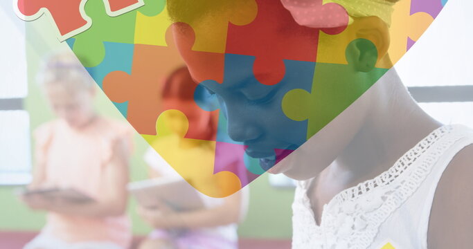 Image of puzzle over diverse schoolchildren
