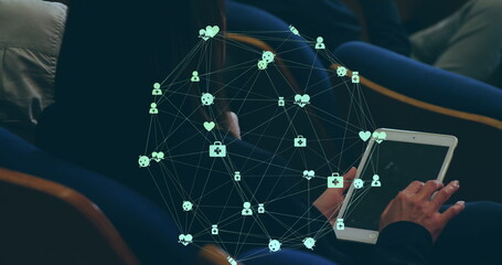 Image of globe of connections with icons over caucasian businesswoman using tablet