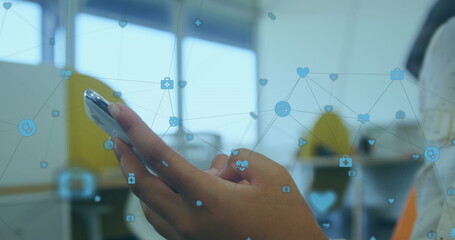 Image of network of connections over person using smartphone