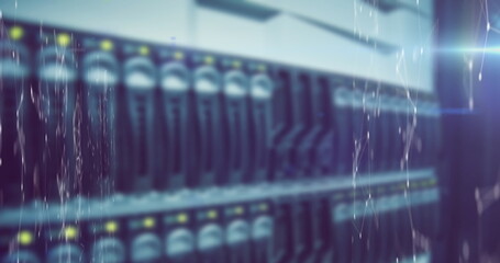 Image of network of connections and light trails over server room