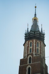 Historic church tower stands tall for architectural reference in Krakow, Poland. Useful for travel, architecture, or European landmark search queries.