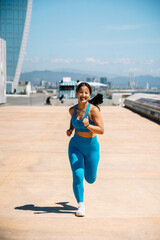 Woman jogging on urban rooftop with cityscape