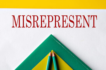 MISREPRESENT - word close-up on white sheet with folders and pencils