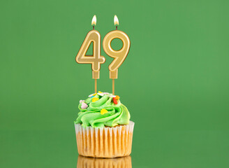 Birthday card with candle and cupcake - Number 49 on a green background