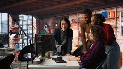 Cheerful startup team cheering after seeing live market updates showing stocks raising, doing high five. Joyous venture staff members overjoyed after becoming publicly traded company, camera A