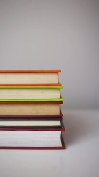 Sliding stack of books on white background