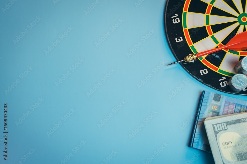 Aufkleber business concept. dartboard with red dart and stack of money on blue background for concept of inves