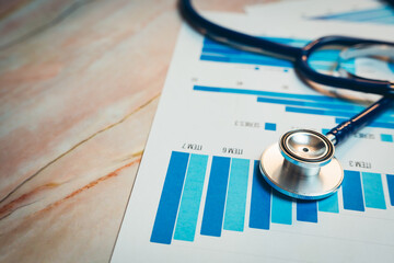 Health care concept. Stethoscope on Business Reports with Blue Graphs and Charts for Healthcare and...