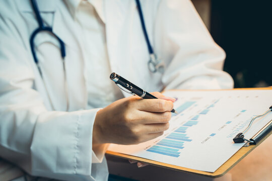 Medical concept. Medical Professional Analyzing Health Data on Clipboard in Clinical Environment