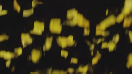 Seamless looping animation of yellow confetti falling on black background for Black Friday Promotion Video - Powered by Adobe