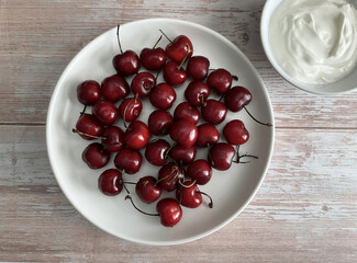 Fresh Red Cherries and Yogurt on Rustic Table - Flat Lay
