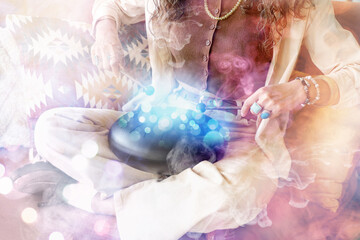 Young witch playing glucophone on sofa at home, closeup