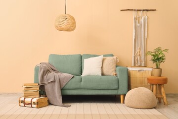 Stylish interior of living room with green sofa
