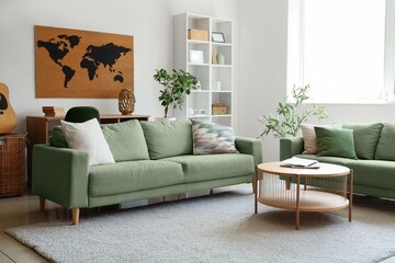 Green sofas, table and world map in interior of living room