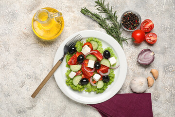 Composition with plate of tasty Greek salad, fork and ingredients on light background
