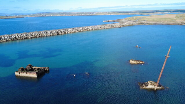 WW1 Blockships (sunken vessels) and one of the four WW2 Churchill Barriers (causeway) used to protect the Scapa Flow anchorage on Orkney, Scotland, which was the UK's main naval base during both world