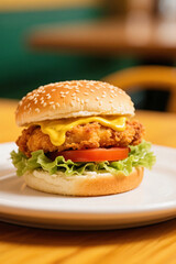Cheesy chicken burger with salad and tomatoe slices