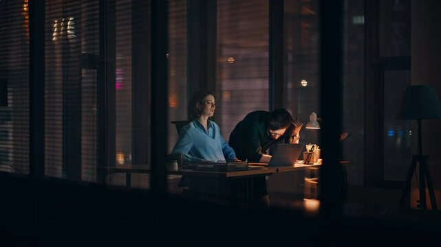 Business team frustrated bad news at laptop working overtime in dark office. 