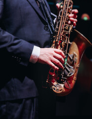 Concert view of saxophonist musician, saxophone sax player with vocalist and musical band during...