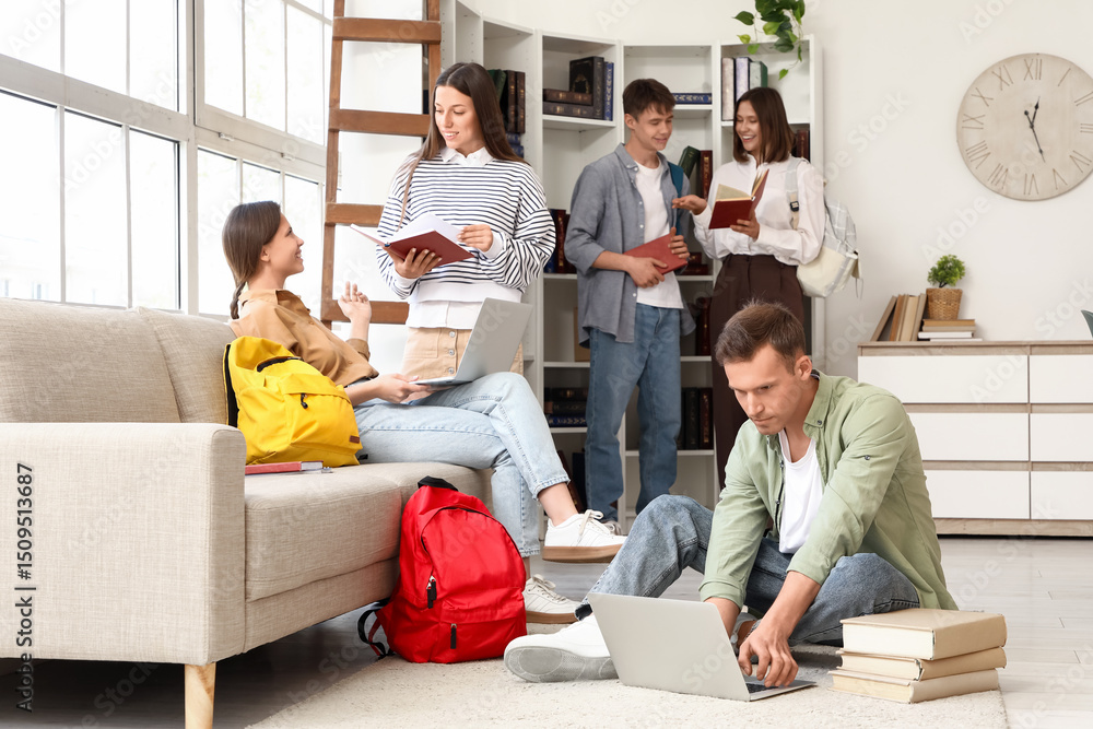 Poster group of students studying with laptops and books in library