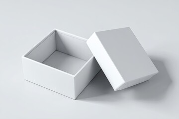 A pristine white square box, slightly ajar, rests on a minimalist grey background; its lid sits beside it, casting subtle shadows