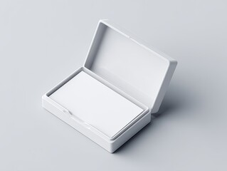 A slightly-opened white rectangular box, containing a stack of blank white business cards on a light gray background