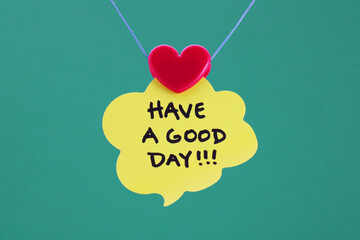 Heart holding speech bubble with HAVE A GOOD DAY phrase