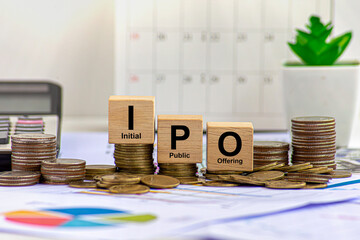 IPO ( Initial Public Offering), Red arrow on coins money and ipo word on natural green background,...