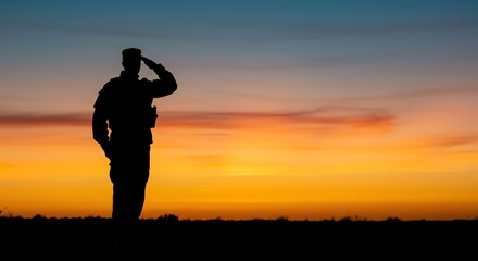 Soldier silhouette saluting against colorful sunset sky