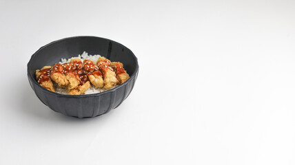 Rice bowl with chicken katsu and topped with sauce and sesame seeds