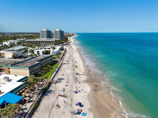 Tourists and locals enjoying a beautiful sunny beach day along the shores of Vero Beach in Indian...