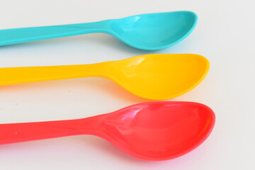 colorful spoon isolated on white background, plastic cutlery for picnic