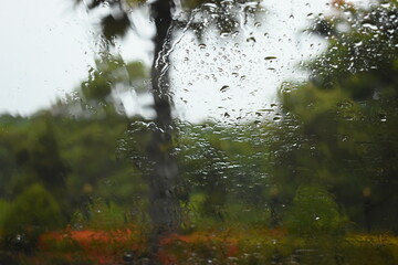 water drop on mirror in rainy day, blur natural background
