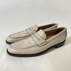 Elegant cream colored loafers with detailed texture for contemporary fashion