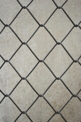 old wire mesh on dirty wall, construction industry