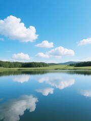 Fototapeta premium Calm Lake Reflecting Blue Sky and White Clouds with Surrounding Forest
