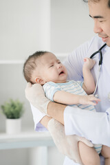A male doctor meticulously examines a three-month-old infant, conducting a thorough health checkup...