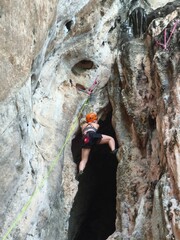 climber on a rock Female athlete top rope rock climbing at Railay Beach, Ao Nang, Krabi Province,...