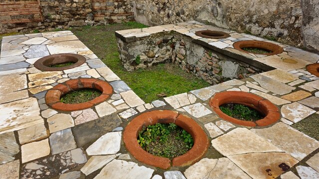 Pompeii, Italy - 8 January 2025. Well-preserved thermopolium in Pompeii with marble counters and embedded dolia, once used for serving food and drinks in this ancient Roman street-side eatery.