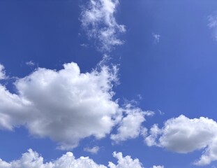 Azure expanse adorned with fluffy clouds