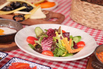 Fresh and colorful salad with assorted ingredients on table