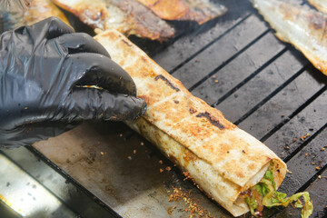 Handmade grilled wrap is prepared on a hot grill