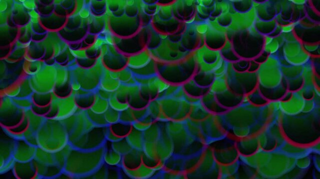 A burst of colorful black, green, and yellow balls falling above in a graceful and artistic pattern. abstract