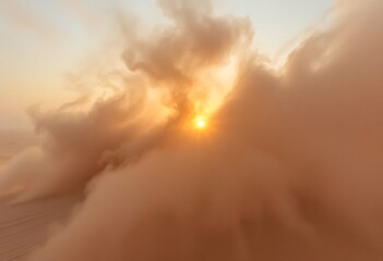 sun is setting behind the clouds in the desert