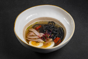 chicken noodle soup. curry soup close-up Japanese food Chinese dish. chicken soup with turkey and black spaghetti.